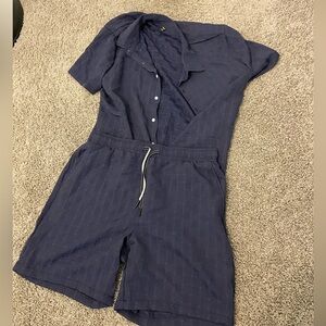 Light blue buttoned up shirt paired with its same colored string shorts